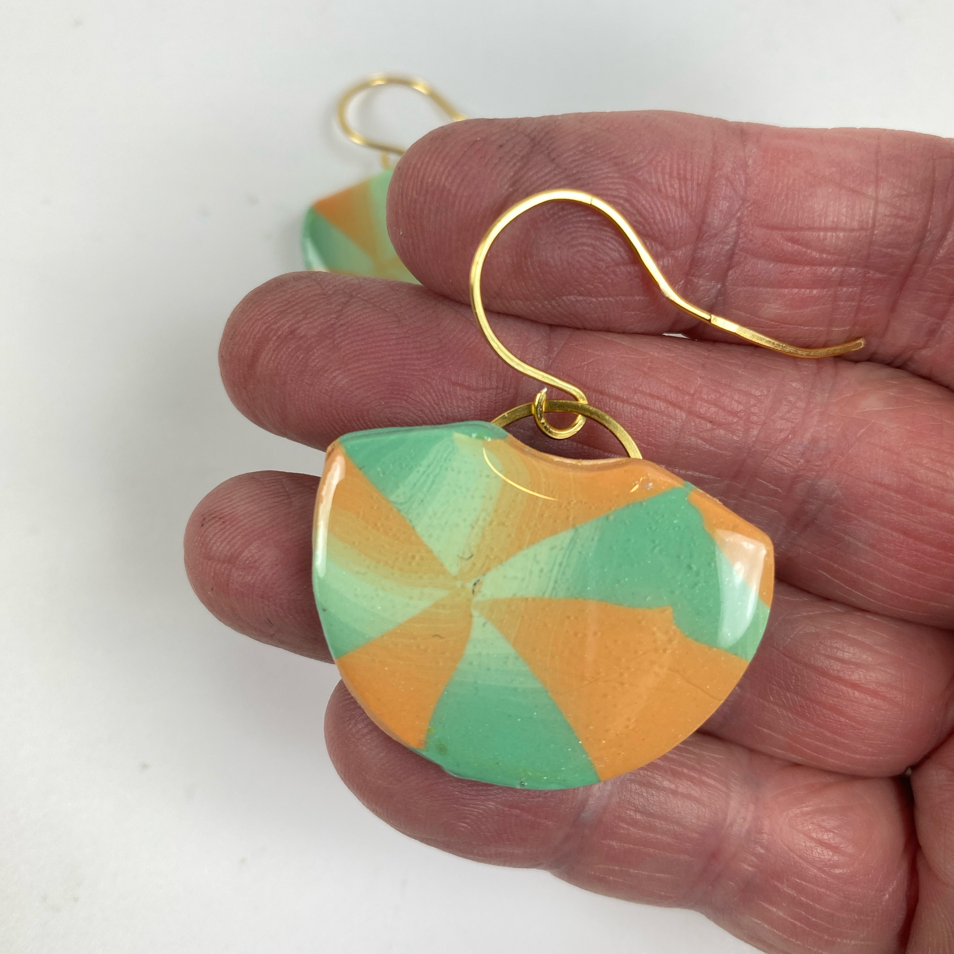 Desert Fan Handmade Polymer Clay Earrings handheld for size reference