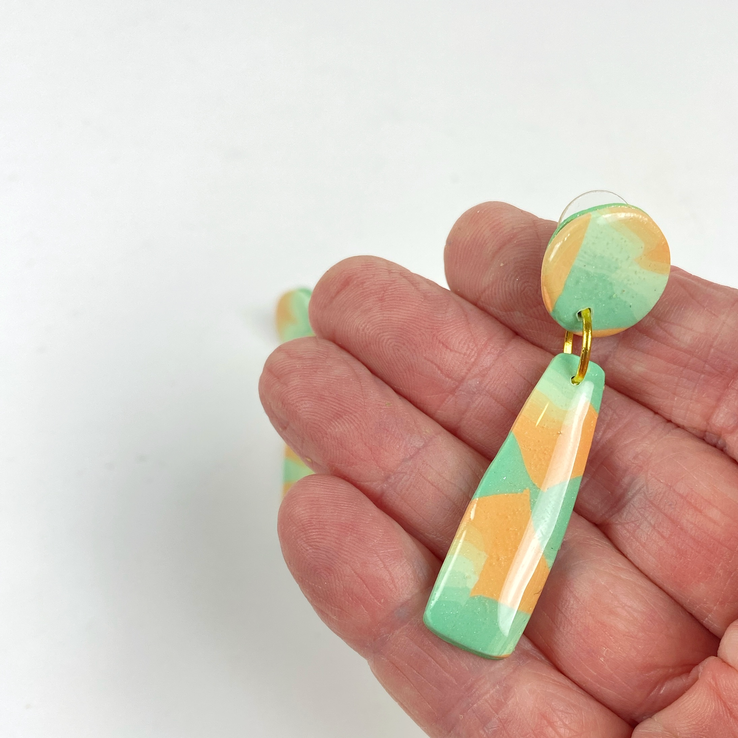 Desert Dangle Earrings handheld for size reference.
