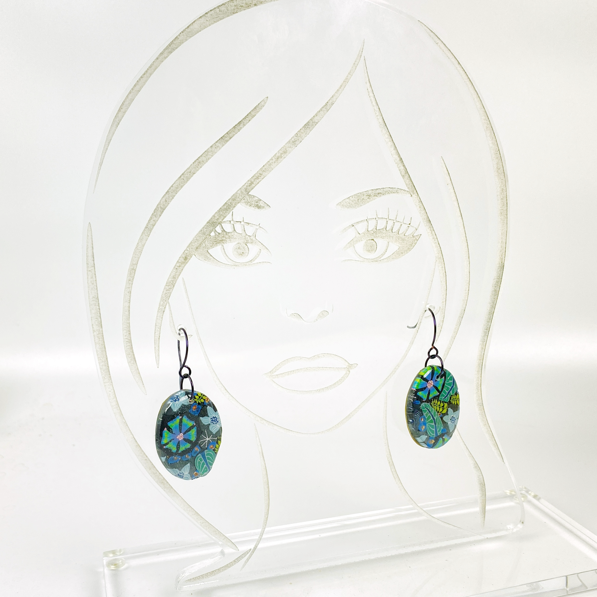 Night Blossom Handmade Polymer Clay Dangle Earrings II on an acrylic display head