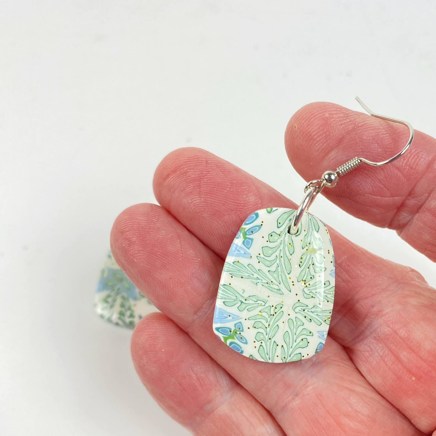 Blue Blossom Handmade Polymer Clay Pendent Earrings handheld for size reference
