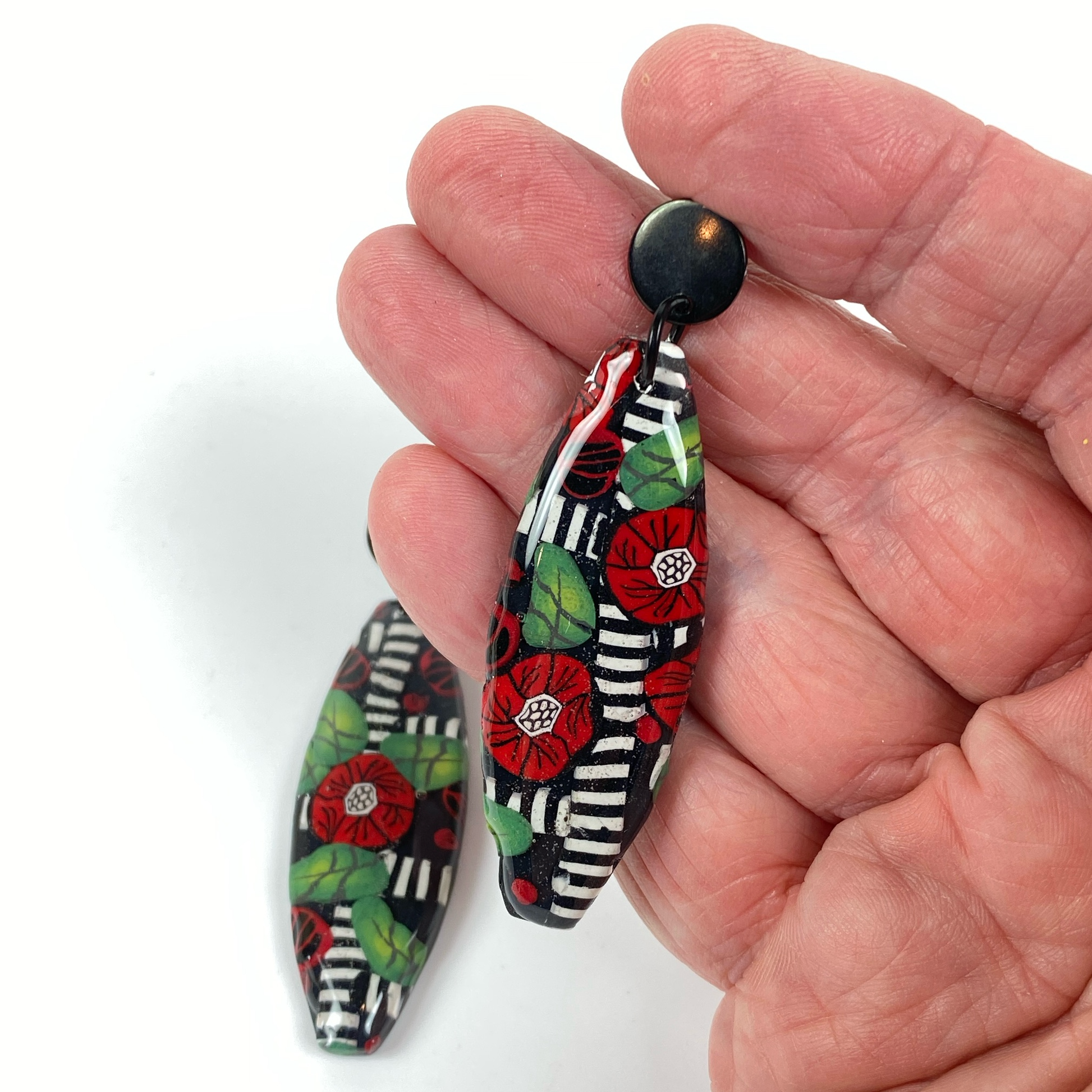Red Lattice Rose Handmade Polymer Clay Earrings handheld for size reference