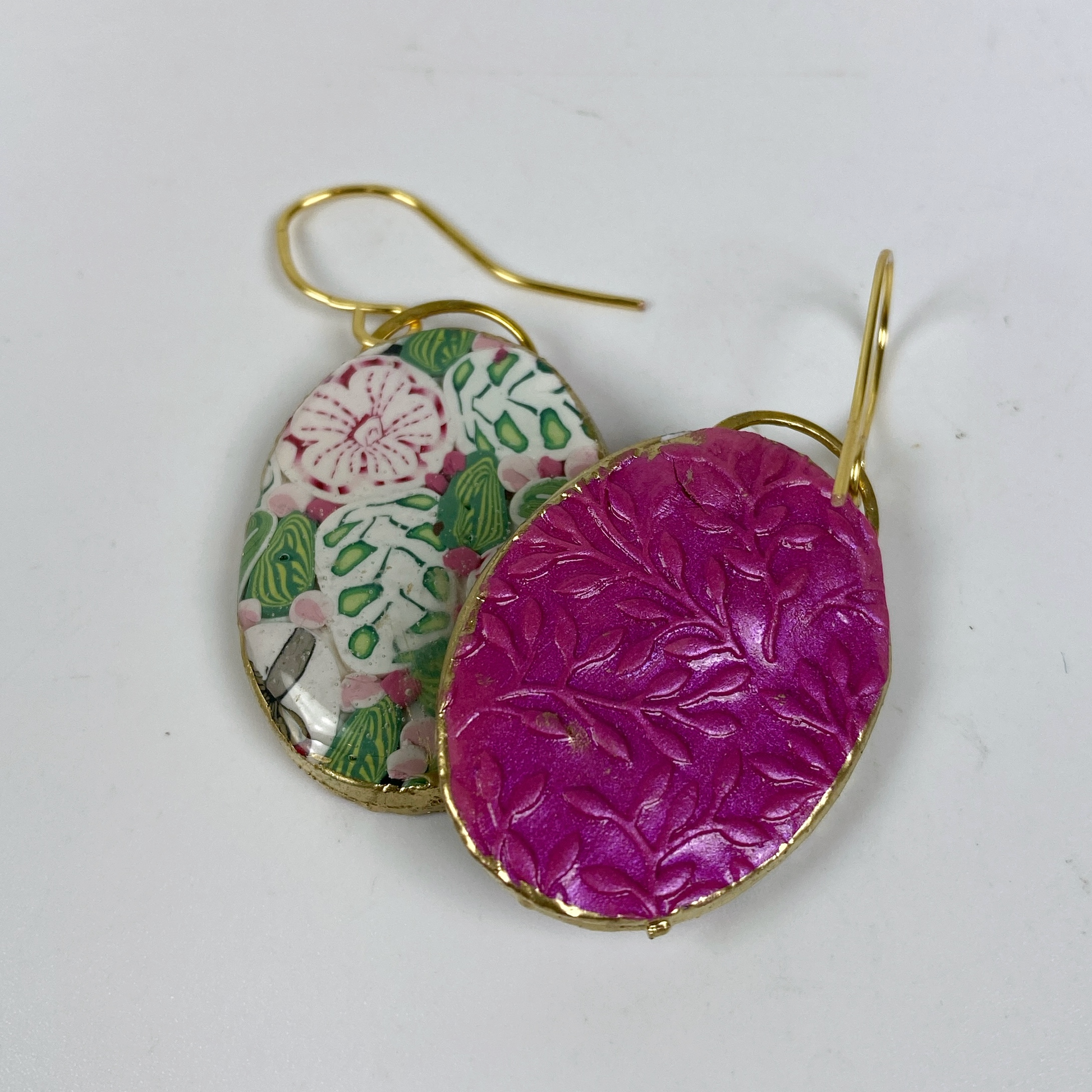 Pink Woodland Handmade Polymer Clay Oval Dangle Earrings showing the embossed hot pink background