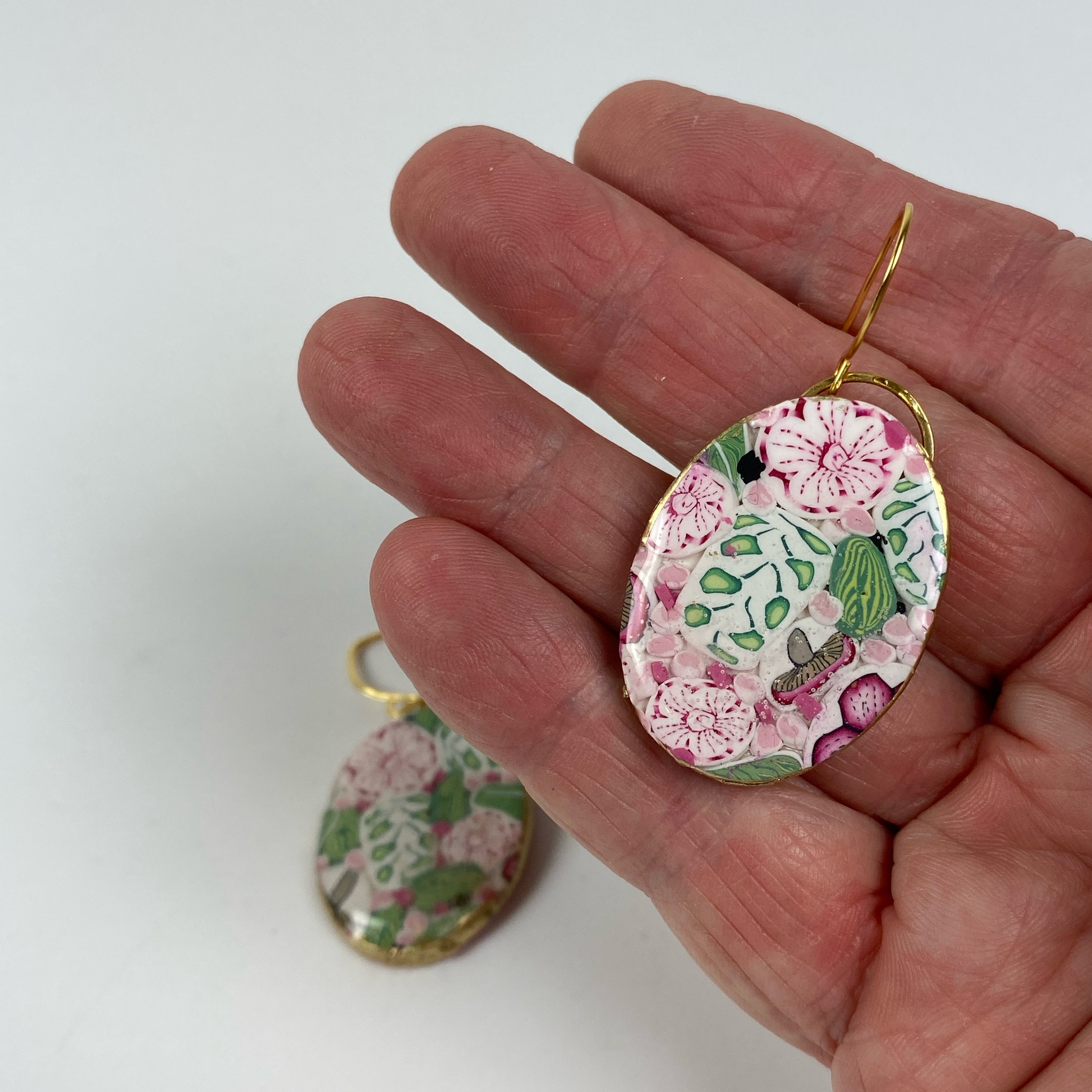 Pink Woodland Handmade Polymer Clay Oval Dangle Earrings handneld for size reference