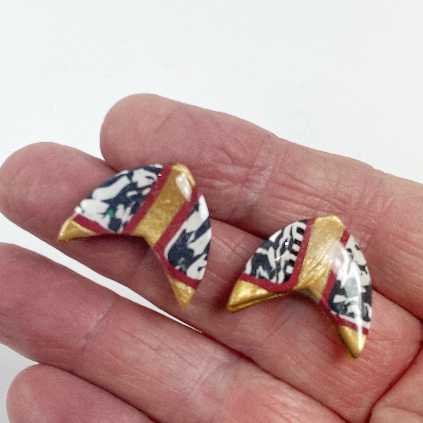 Red and Gold Handmade Polymer Clay Boomerang Stud Earrings handheld for size reference