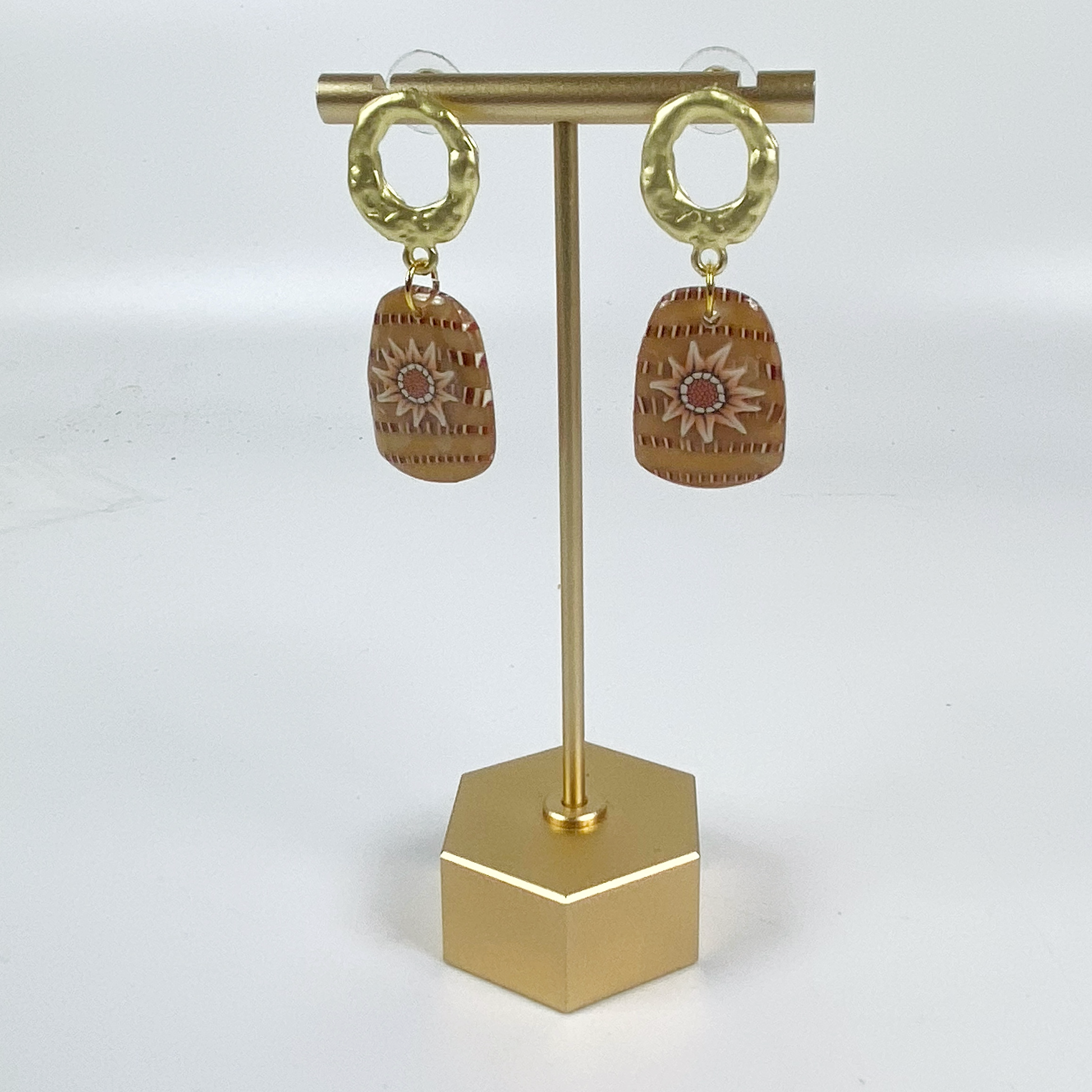 Saffron Daisy Polymer Clay Earrings on brass display stand.
