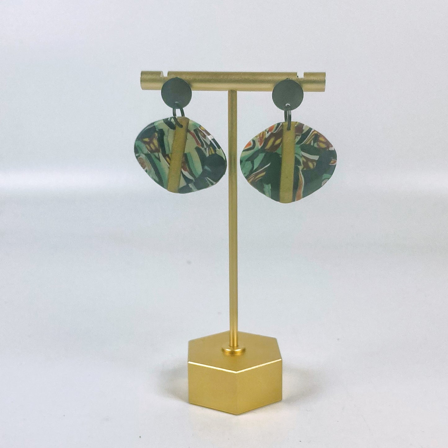 Black Green and Gold Handmade Polymer Clay Dangle Earrings on a brass earrings stand