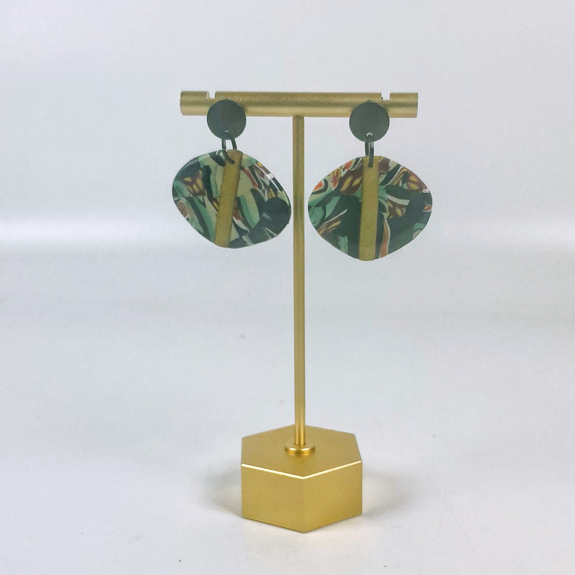 Black Green and Gold Handmade Polymer Clay Dangle Earrings on a brass earrings stand