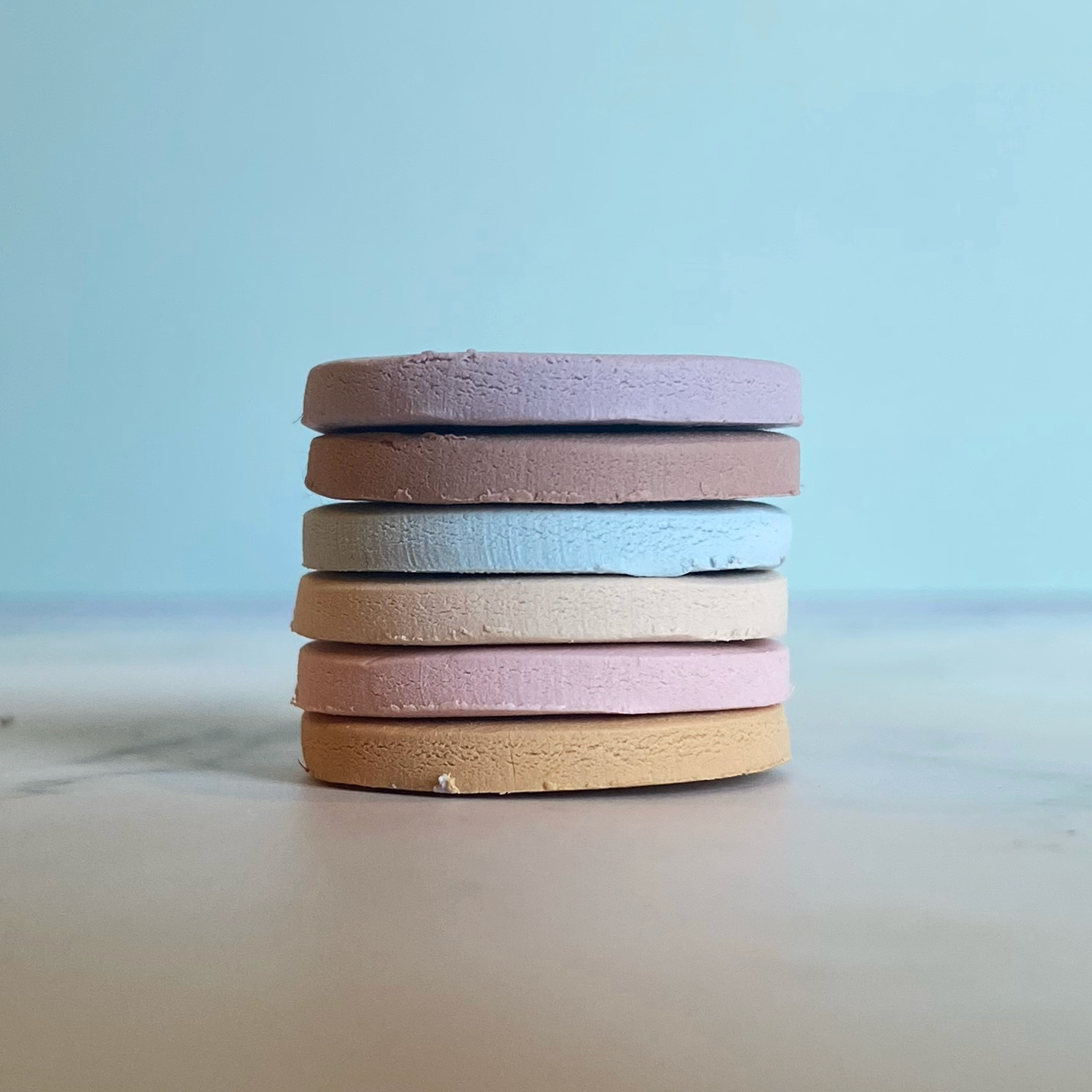 Modern Mom clay color sample discs stacked.