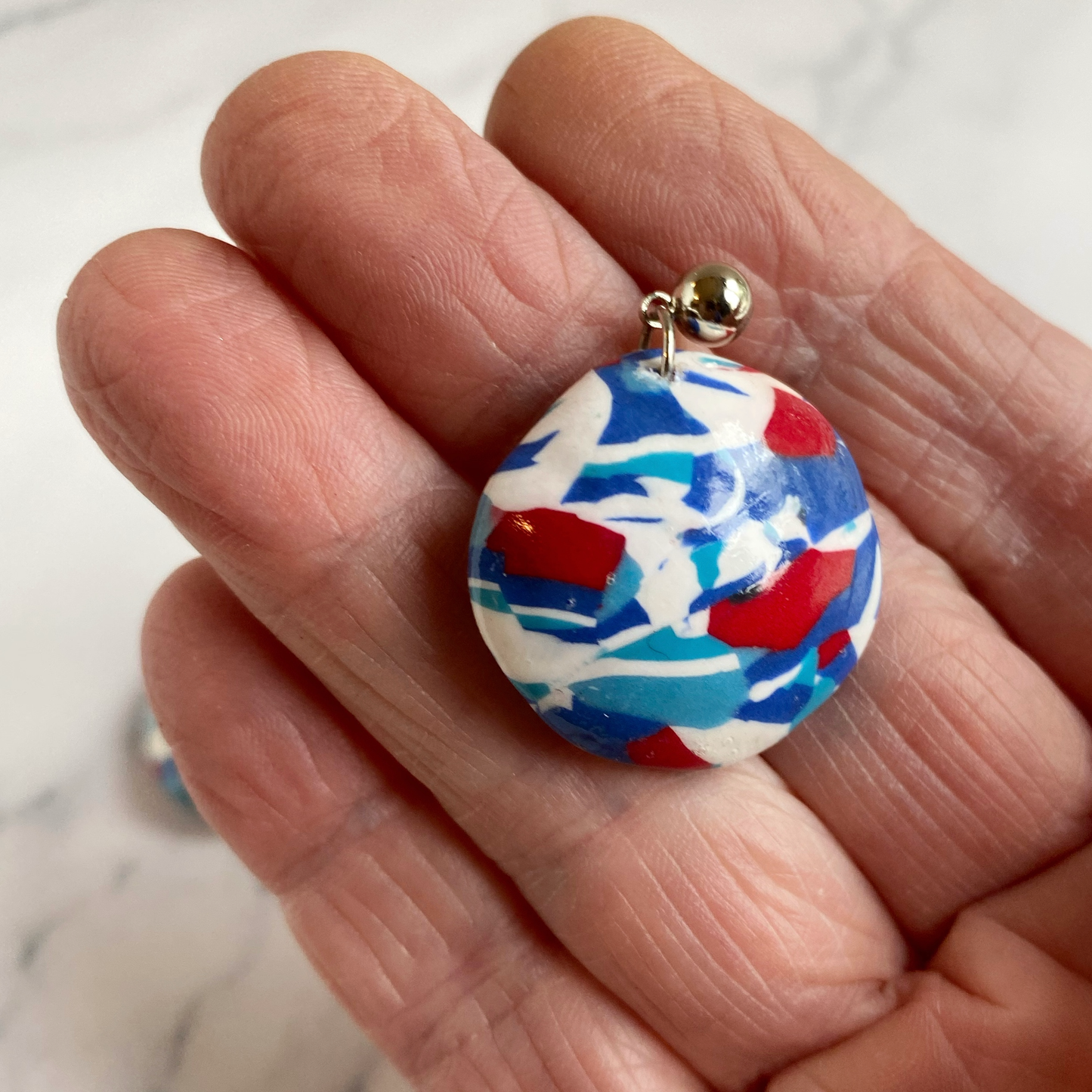 Handmade Polymer Clay Red White and Blue Earrings, handheld for size reference