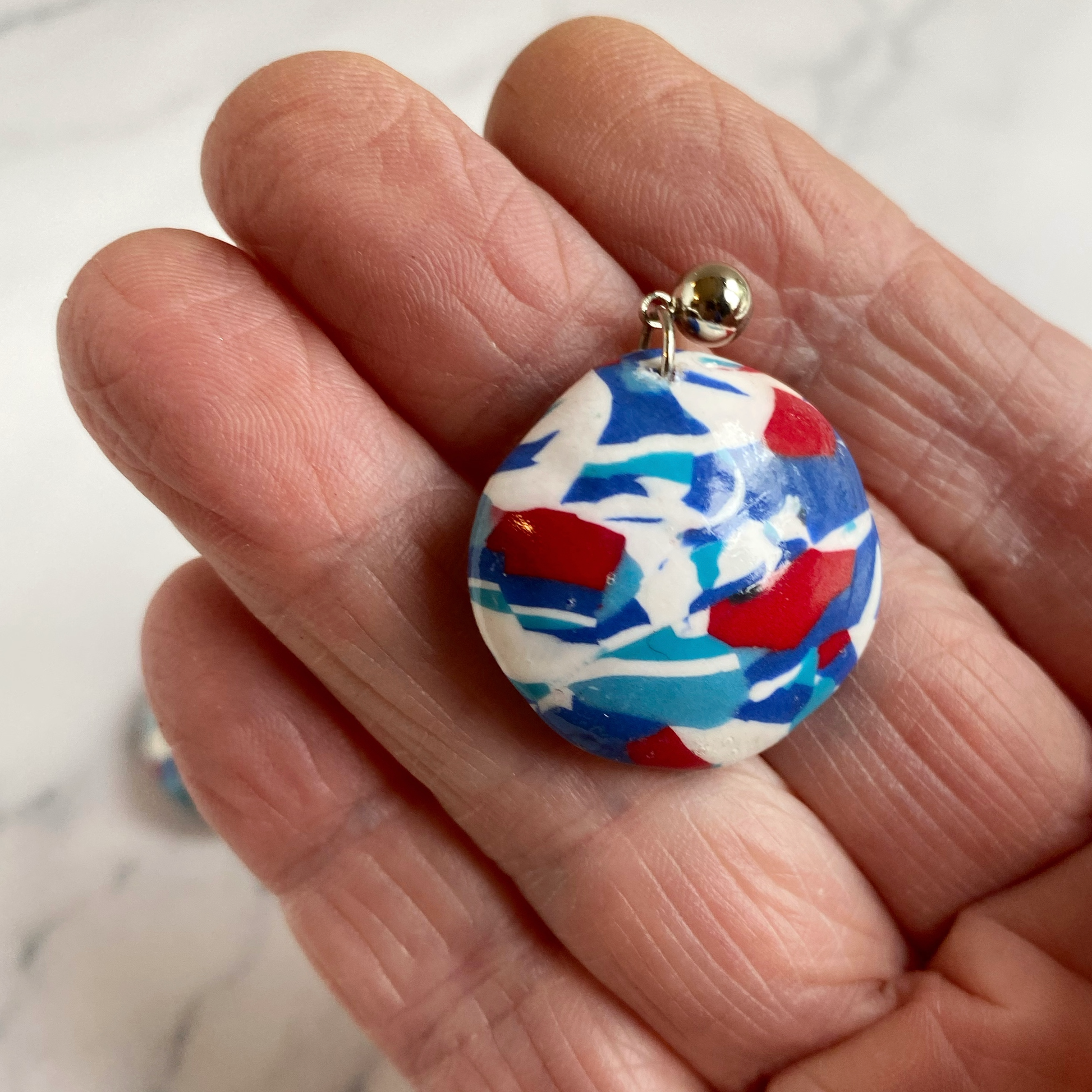 Handmade Polymer Clay Red White and Blue Earrings, handheld for size reference
