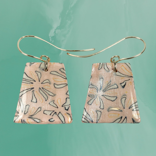 Polymer Clay Handmade Pink Dangle Earrings on a pale teal background