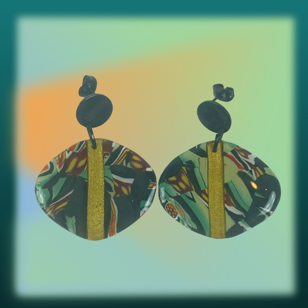 Black Green and Gold Handmade Polymer Clay Dangle Earrings on a green background