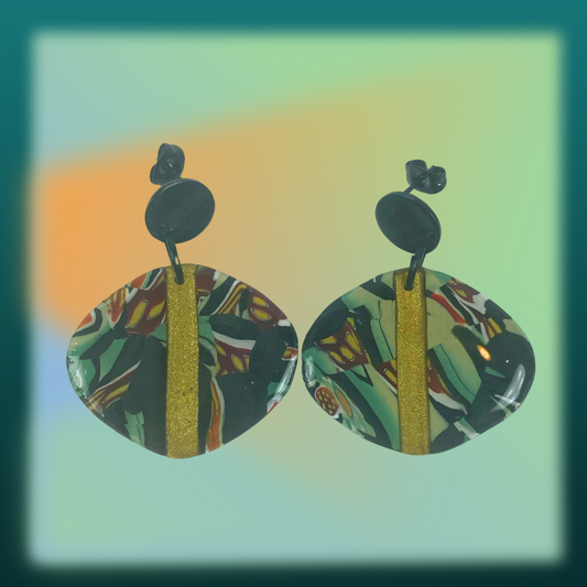 Black Green and Gold Handmade Polymer Clay Dangle Earrings on a green background