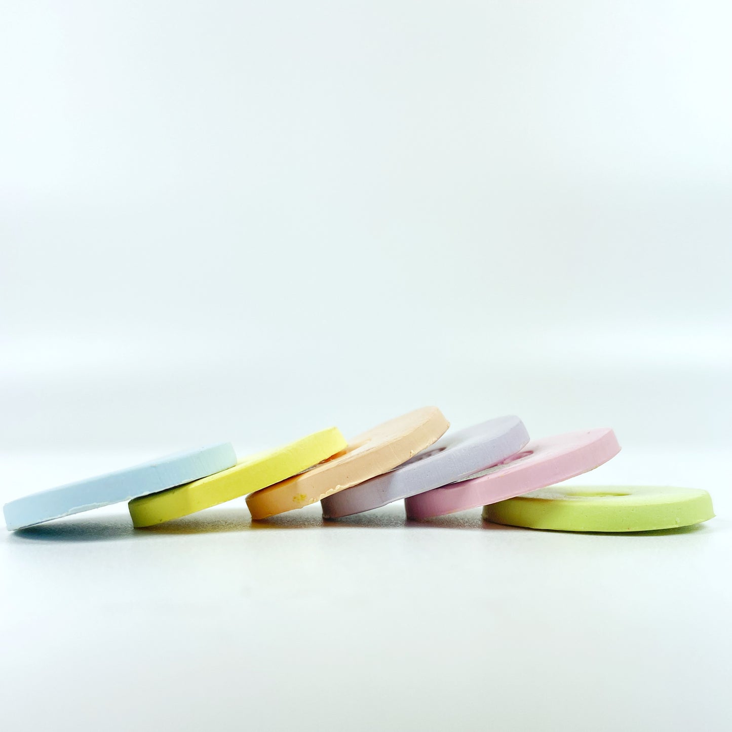 The 6 polymer clay colors of Peaceful Easter Palette shown in sample discs stacked in a cascade.